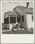 Farmsteader's wife painting kitchen furniture. Falls City Farmsteads, Nebraska