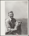 Elmo Temple, Chaffee County, Colorado rehabilitation client poses with one of his lambs