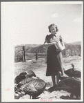 Mrs. Louise Temple feeds some of her turkeys on their farm in Chaffee County, Colorado