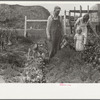 Mr. and Mrs. Howard Crowder and daughter in their garden, San Luis Valley Farms, Alamosa, Colorado