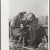 Farmer and son at refreshment stand, mechanical corn picker contest, Hardin County, Iowa