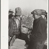 Farmers examine exhibit of hybrid corn, mechanical cornhusking contest, Hardin County, Iowa