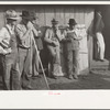 Farmer's neighbors who have come to buy livestock and equipment at farm sale, Pettis County, Missouri