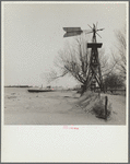 Windmill and tank on an abandoned farm. Cimarron County, Oklahoma