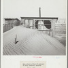 Sand piled up in front of outhouse on farm. Cimarron County, Oklahoma