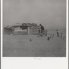 Farmer and sons walking in the face of a dust storm. Cimarron County, Oklahoma
