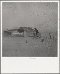 Farmer and sons walking in the face of a dust storm. Cimarron County, Oklahoma