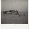 Farmer and sons walking in the face of a dust storm. Cimarron County, Oklahoma