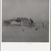 Farmer and sons walking in the face of a dust storm. Cimarron County, Oklahoma