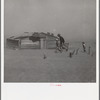 Farmer and sons walking in the face of a dust storm. Cimarron County, Oklahoma