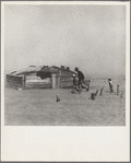 Farmer and sons walking in the face of a dust storm. Cimarron County, Oklahoma