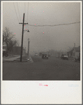 Autos have to turn on lights to penetrate gloom of dust storm. Amarillo, Texas