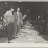 Rehabilitation supervisor examines client's tobacco crop. Durham, North Carolina