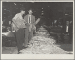 Rehabilitation supervisor examines client's tobacco crop. Durham, North Carolina
