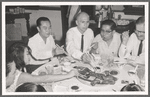 José Limón dining with unknown dinner companions on Asia trip