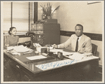 A. Philip Randolph of the Brotherhood of Sleeping Car Porters, seated in his office, with his administrative assistant at typewriter