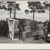 The temporary home of a migrant citrus worker and his family. Now camped near the packing plant of Winterhaven, Florida. The family is originally from Tennessee