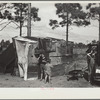 The temporary home of a migrant citrus worker and his family. Now camped near the packing plant of Winterhaven, Florida. The family is originally from Tennessee