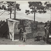 The temporary home of a migrant citrus worker and his family. Now camped near the packing plant of Winterhaven, Florida. The family is originally from Tennessee