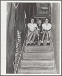 Children of migrant citrus worker who lives in a rundown apartment house. The sink at the head of the stairs is the only running water in the house. Winterhaven, Florida