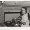 While father and mother are both at work in the citrus packing plant this little girl keeps house. Winterhaven, Florida