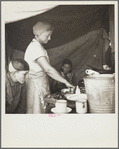 Mother of New Mexico migrants preparing a meal. Deerfield, Florida