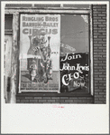 Barber shop window [with circus poster] in Birmingham, Alabama