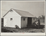 Mr. Cherser unloading some of his farming implements at the barn on his new homestead. Greenwood, [Jefferson County?,] Alabama