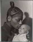 Portrait of a Mother with braided hair holding a young baby
