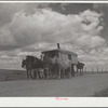 A modern covered wagon family going west for work. Pennington County, South Dakota