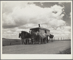 A modern covered wagon family going west for work. Pennington County, South Dakota