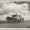 A modern covered wagon family going west for work. Pennington County, South Dakota