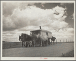 A modern covered wagon family going west for work. Pennington County, South Dakota