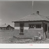 Old sod homestead in background. New house in foreground. Pennington County, South Dakota