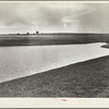 Completed stock water dam which will benefit ranch in background. Pennington County, South Dakota