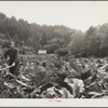 Skunk cabbage, ferns and alders keep this farmer in the hills hard at work as he attempts to clear an abandoned homestead. Oregon