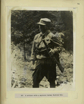 A soldier with a captured German machine gun.