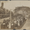 Crowd gathered at a dock for the arrival or departure of a boat