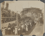 Crowd gathered at a dock for the arrival or departure of a boat
