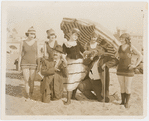 Publicity photograph of Phil Dunham, Alice Howell, and Frank J. Coleman with other Reelcraft Comedy Troupe players in bathing suits on the beach in Hollywood, California during the production of the motion picture Good Night, Nurse
