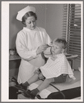 Child being treated in health clinic. Tulare migrant camp. Visalia, California