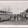 Migrant high school students arriving home from school. Tulare migrant camp. Visalia, California