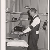 Putting out newspaper. Tulare migrant camp. Visalia, California