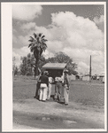 Men in front bulletin board. Tulare migrant camp. Visalia, California