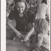 Woman washing clothes. Tulare migrant camp. Visalia, California