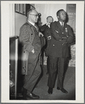 Reverend John H. Johnson (left) and New York Police Department Captain Arthur Hill attending an unidentified police gathering