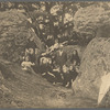 Loie Fuller's students sitting outdoors between rocks