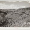 The Deschutes River, like many of the other rivers in the arid portion of central Oregon, is at the bottom of a steep canyon. Stock trails have been built by Resettlement Administration workers to make the water available to cattle