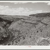 The Deschutes River, like many of the other rivers in the arid portion of central Oregon, is at the bottom of a steep canyon. Stock trails have been built by Resettlement Administration workers to make the water available to cattle