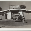 Truck from Kansas City backing into storage cellar for a load of potatoes. Monte Vista, Colorado